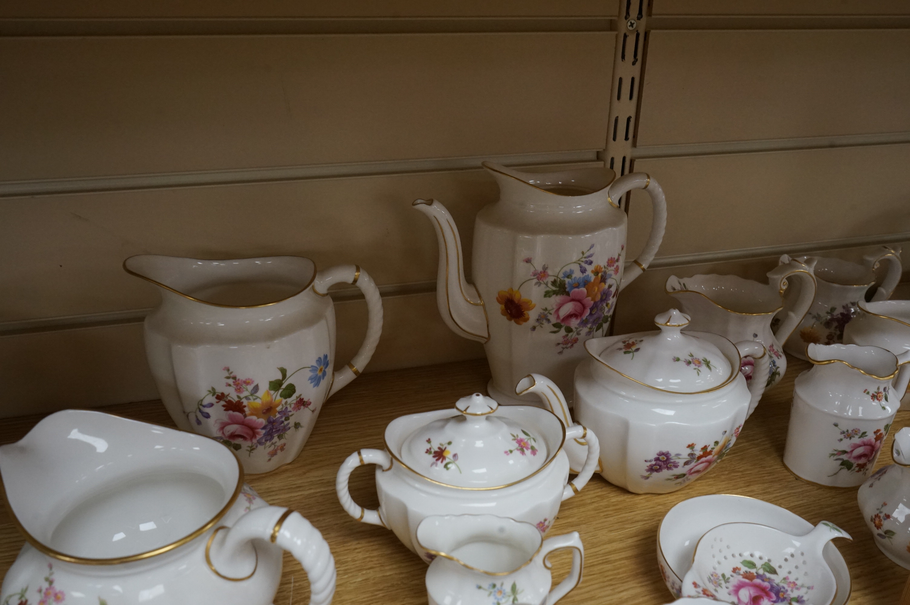 An extensive Crown Derby Posies pattern service to include trios, teapot, jugs and miniatures